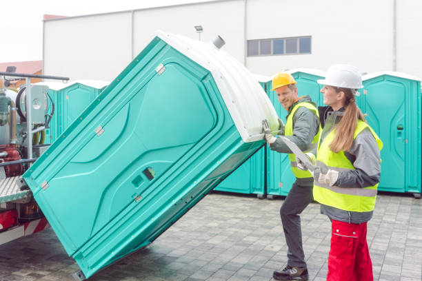 worker loading portable toilets on truck for delivery worker loading portable toilets on truck for delivery